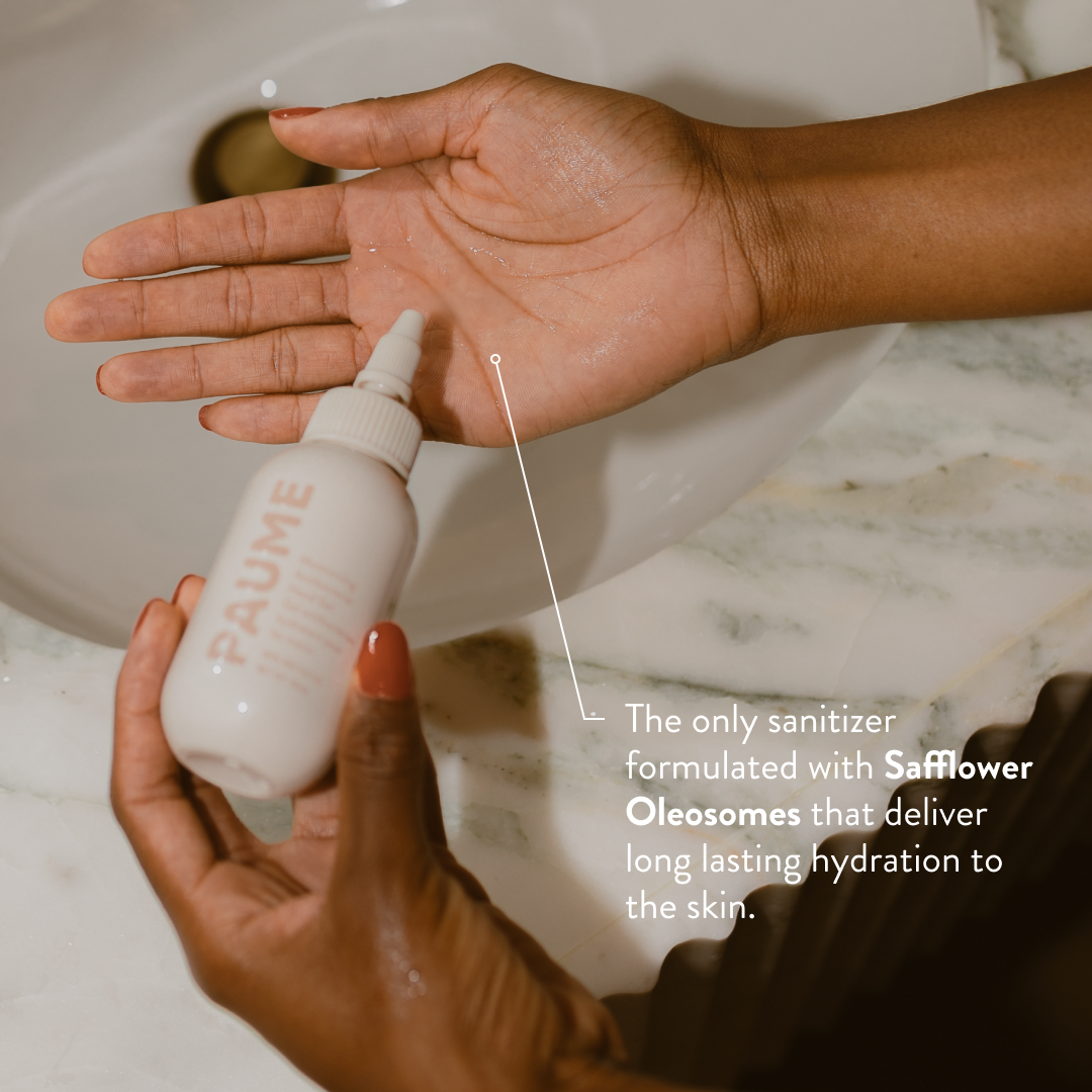 Person applying a white bottle labeled 'PAUMER' to their hand with text about safflower oleosomes.