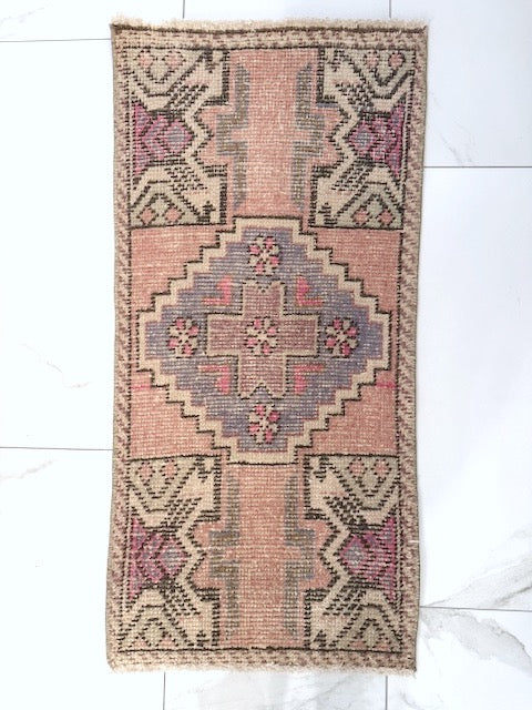 100% wool Woven Turkish rug with geometric pattern on a white floor