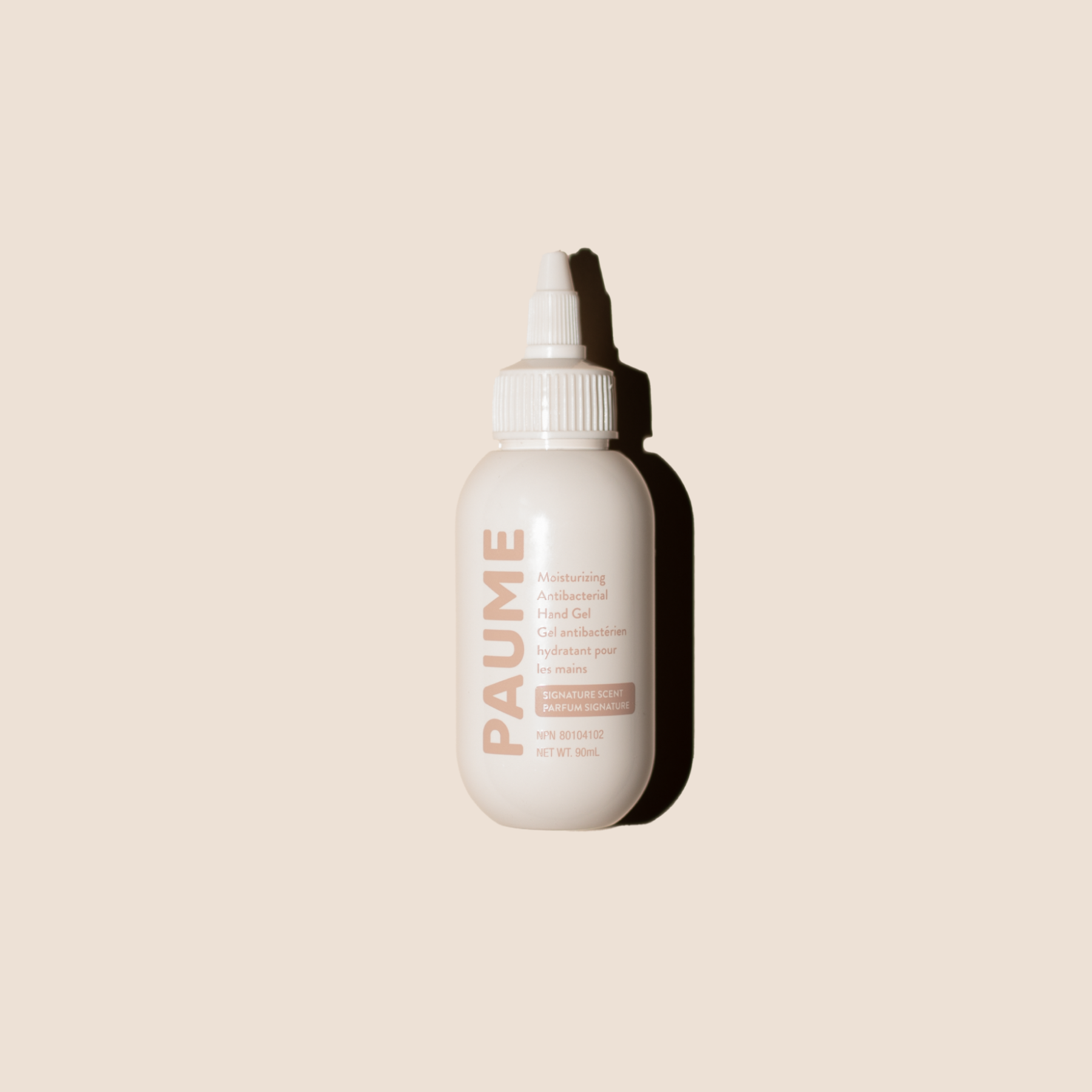 White bottle with 'PAUME' branding on a beige background